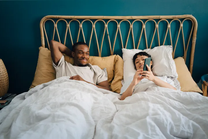 iphone couple on bed from huffpost
